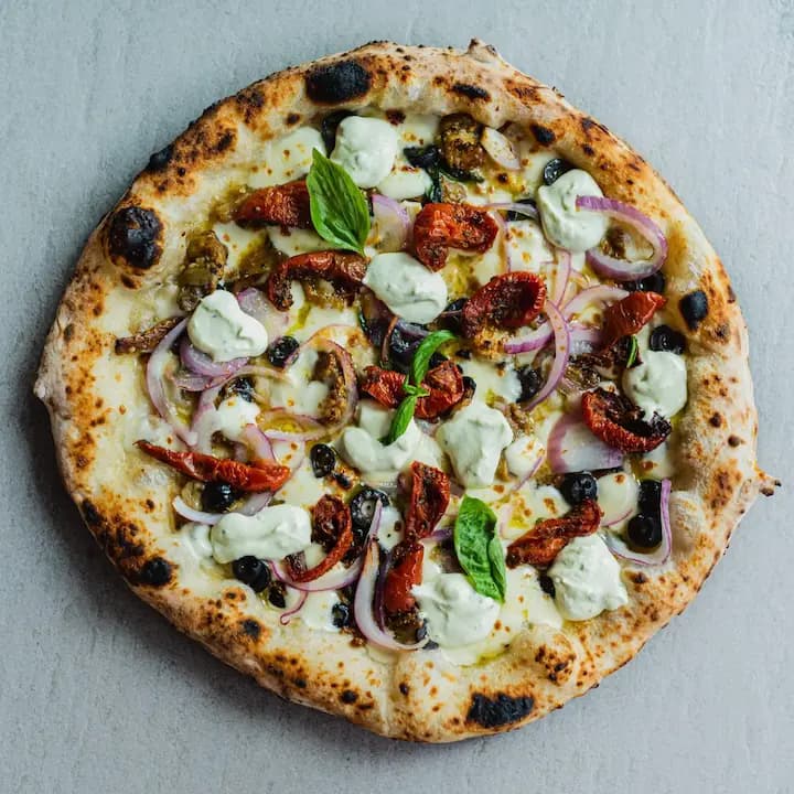 Neapolitan Pizza with anchovies, semi-dried tomatoes & ricotta